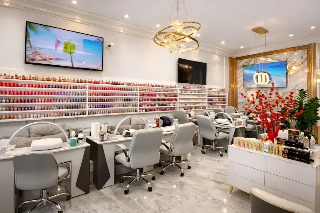 A nail technician at work on a client’s hands