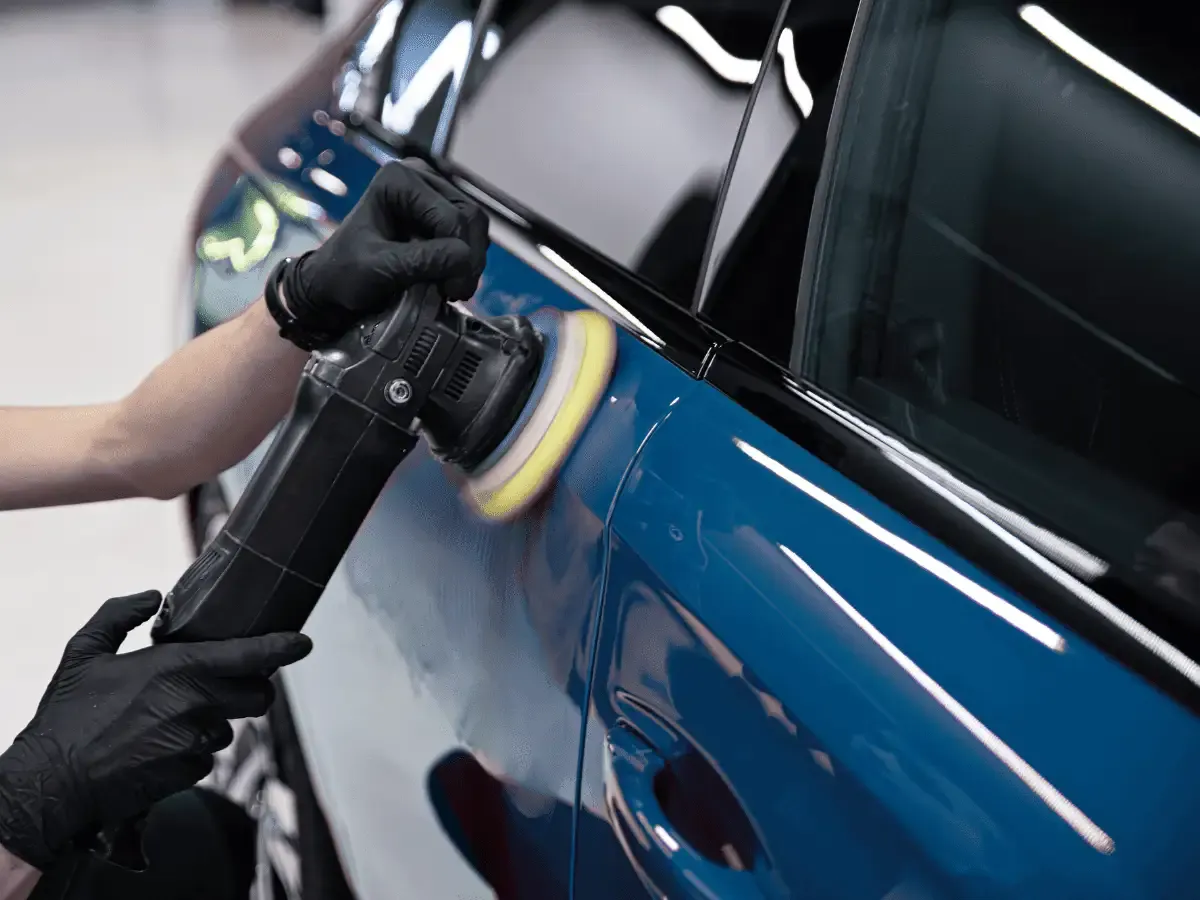A machine polisher correcting paint